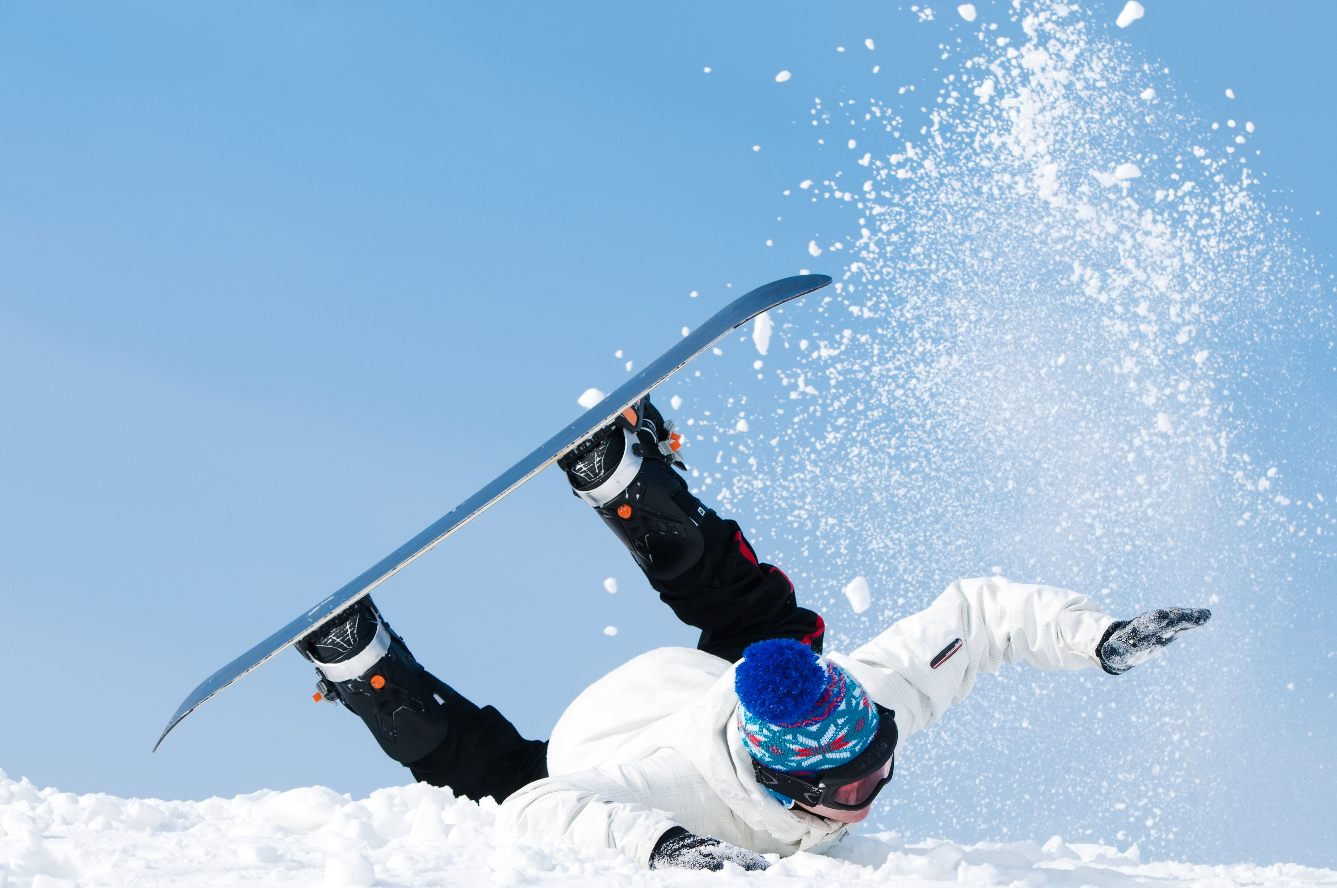 Falling,Young,Man,On,Snowboard,At,Snowy,Winter
